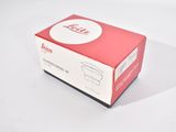 a red box with a white lid on a white surface