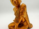 an image of a statue of a person sitting on a white surface