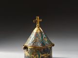 an image of a small blue and gold box with a bird on top