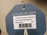 a blue tag with a barcode on it hanging from a hook