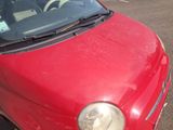 a red car that is parked in a parking lot