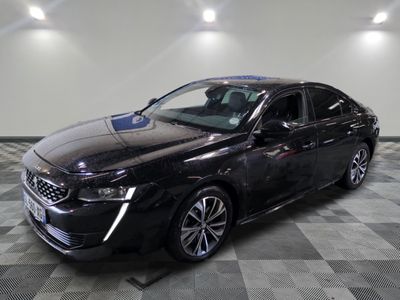 the black car is parked on a checkered floor in the garage