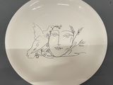 a white plate with a drawing of a bird on it