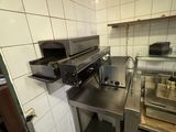 an image of a commercial kitchen with stainless steel counter tops