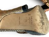 pair of women ' s shoes on a white surface with a snake skin pattern