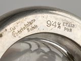 an antique silver plate with writing on the side of it