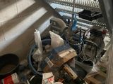 a pile of assorted items on the floor next to a staircase
