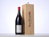 a bottle of wine sitting next to a wooden box