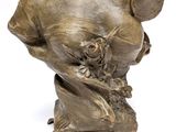 an antique bronze bust of a woman holding a baby on a stand