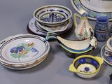 many different types of dishes and bowls on the table