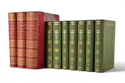 several books are lined up in a row on a white surface
