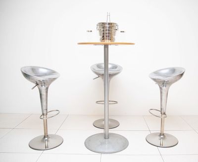 trois tabourets et une table dans une pièce