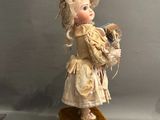 a doll that is standing on top of a box