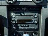 a close up of a car ' s dashboard with a cup holder in the center