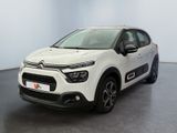 a white citrole is parked in a large room