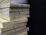 many books stacked on top of each other on a table
