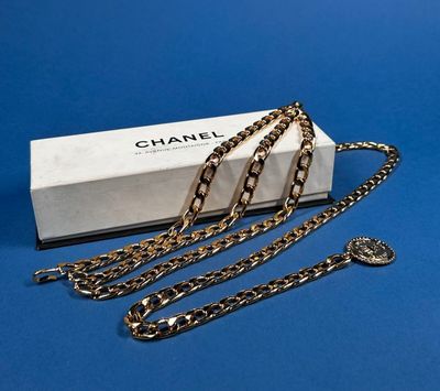 a close up of a box with a chain on a blue surface