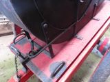 an image of a black and red boat on a trailer