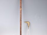 a wooden stick and a knife on a white surface