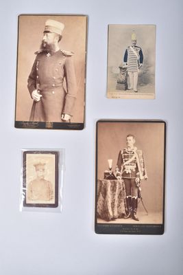 several old photos of men in military uniforms are on a wall