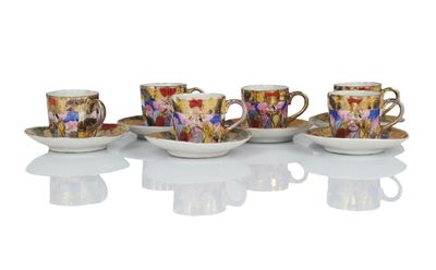 four coffee cups and saucers are lined up on a white surface