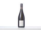 a bottle of wine sitting on top of a white table