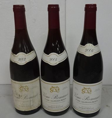 three bottles of wine are lined up on a table