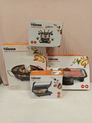 three boxes of food sit on a white surface with a pink background