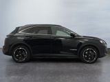 the black suv is parked in a large room with a sky background