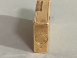 a gold lighter that is sitting on a table
