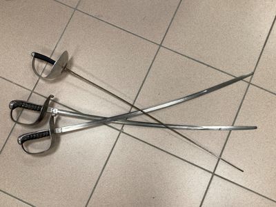 two swords laying on the floor next to each other