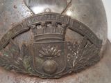 a metal helmet with a crest on it