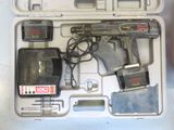 a tool in a case with a cord and a battery