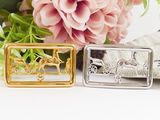 a picture of a silver and gold belt buckle with a horse drawn carriage