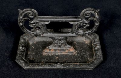 a small metal object that is on a black surface