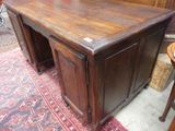 a wooden desk with two drawers on top of it