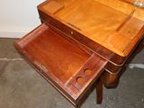 a small wooden table with a drawer on it