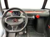 the interior of a car with a steering wheel and dashboard controls