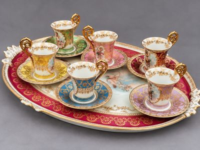 a tray with cups and saucers on it on a table