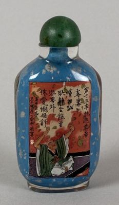 a blue glass bottle with a painting on it