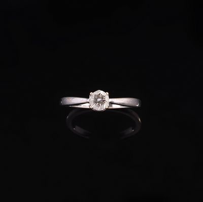 a close up of a diamond ring on a black surface