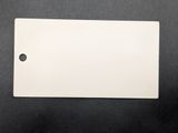 a close up of a piece of white paper on a black surface