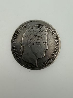 a close up of a coin on a white surface