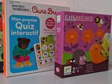 several children ' s books are lined up on a white surface
