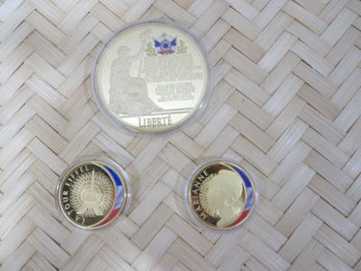 three coins sitting on top of a woven table next to each other
