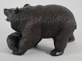 a black bear figurine on a white background