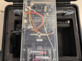 a black box with wires and a battery in it