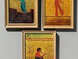 three framed paintings of a woman and a man playing a game of golf