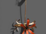a metal sculpture of a flower hanging on a wall
