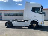 a white semi truck parked in front of a building